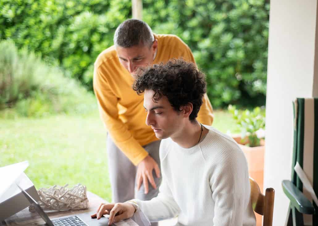 Father and son using computer