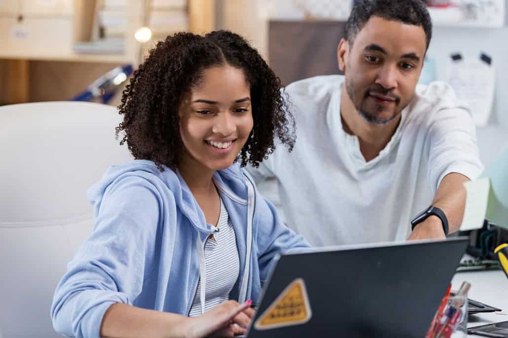Father and daughter using laptop