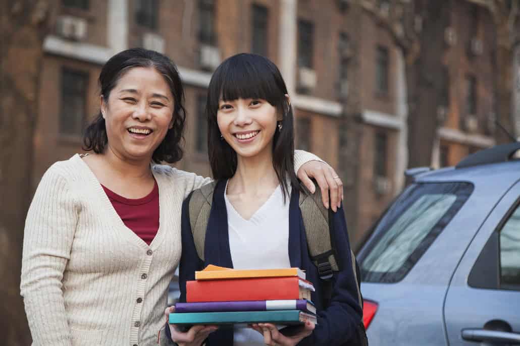 Mom with daughter outside holding books
