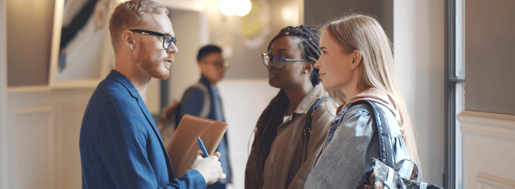 Professor talking to 2 students